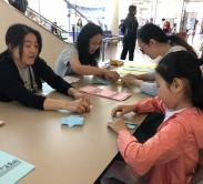 learning how to fold an origami yukata kimono at 2019 Natsumatsuri Family Festival