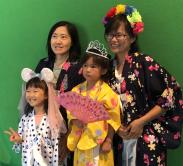 family posing for a picture at the 2019 Natsumatsuri Family Festival summer photo booth