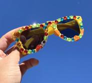 Yellow sunglasses decorated with jewels and stickers