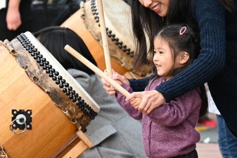 little girl playing taiko drum