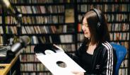 Action shot of changemaker Emma Anderson holding a vinyl record.