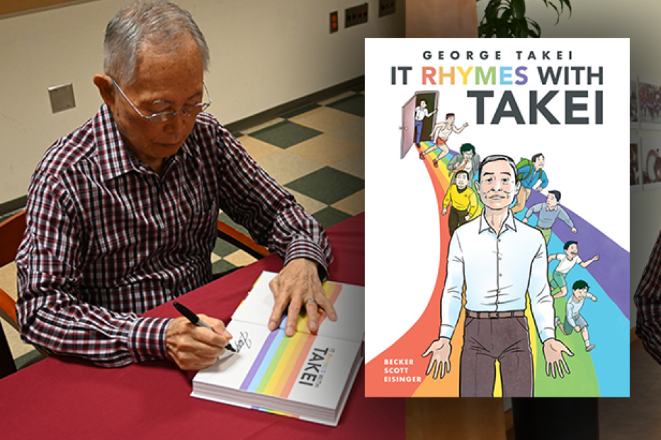 George Takei signing, hold his book