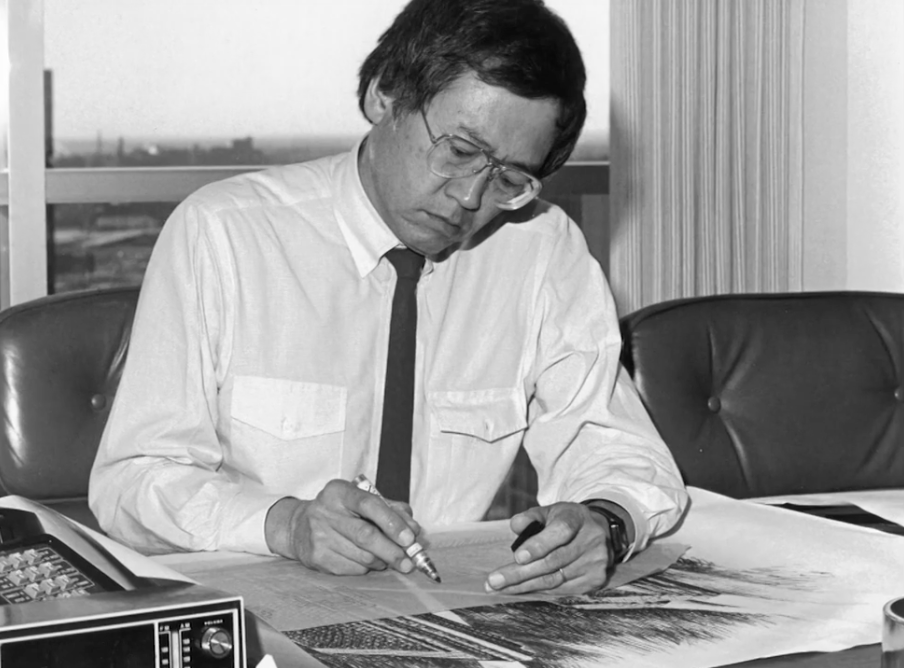 black and white photo of Gyo Obata working at a desk