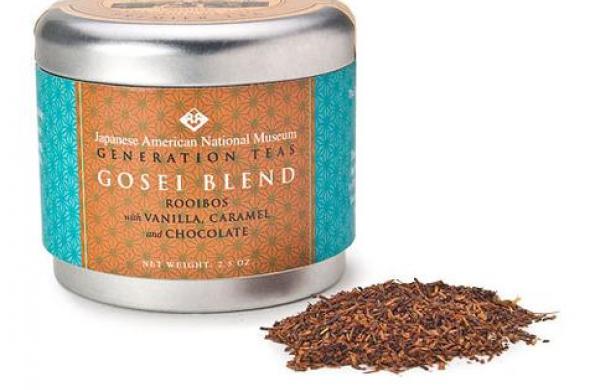 tin canister with orange and turquoise label that says "Japanese American National Museum Generation Teas Gosei Blend" and a small scoop of tea leaves sitting next to it