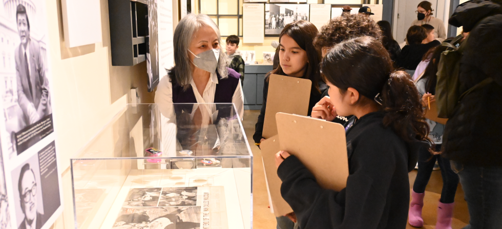 volunteer giving students tour of museum