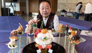 Shinobu "Shan" Ichiyanagi with candy sculptures of the animals of the Chinese Zodiac.
