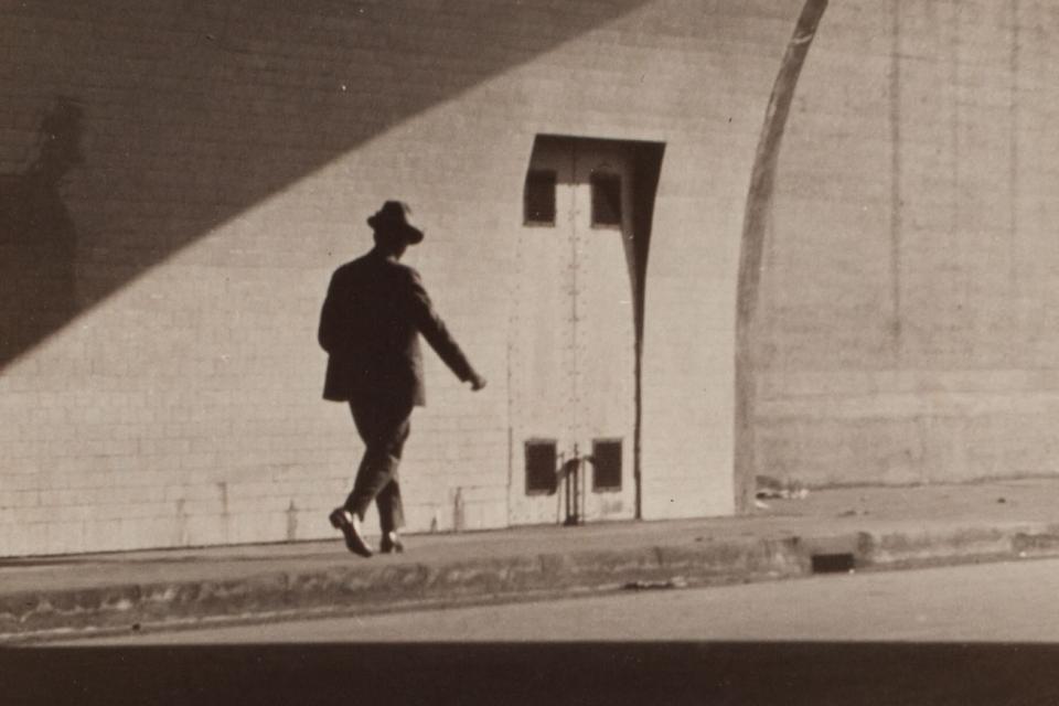 man walking out of tunnel