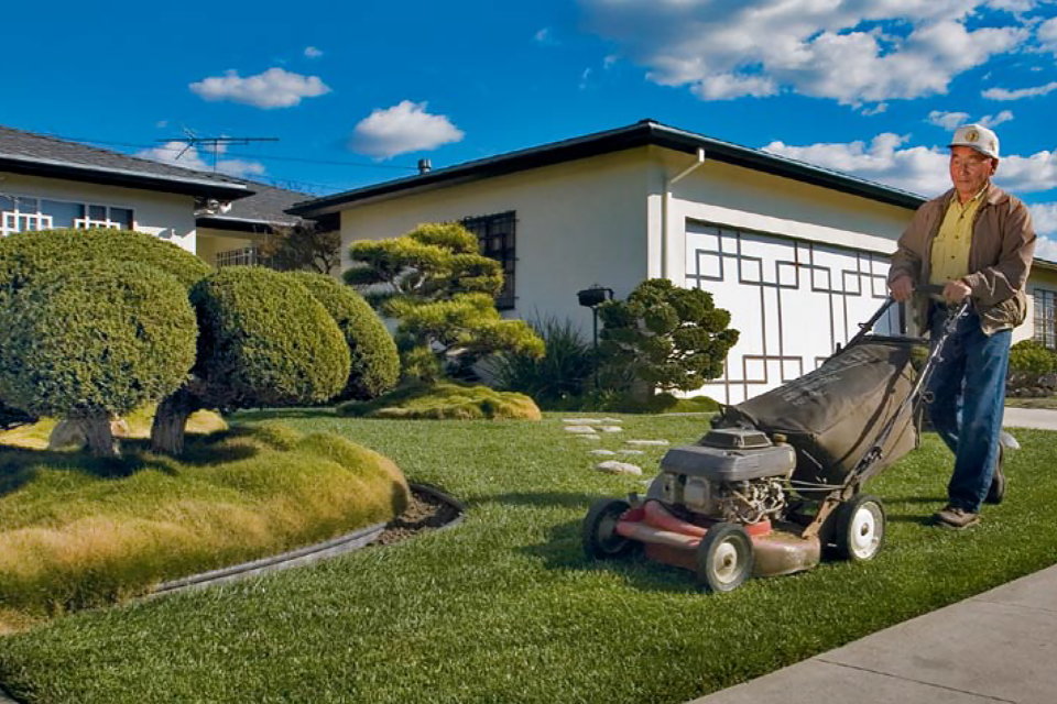 japanese gardener mowing lawn