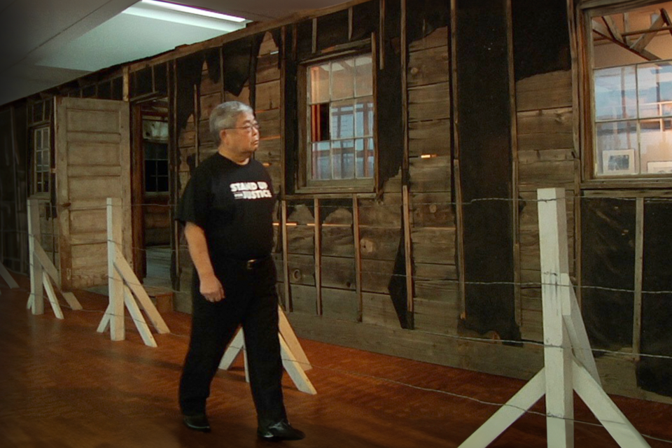 man looking at barrack in museum