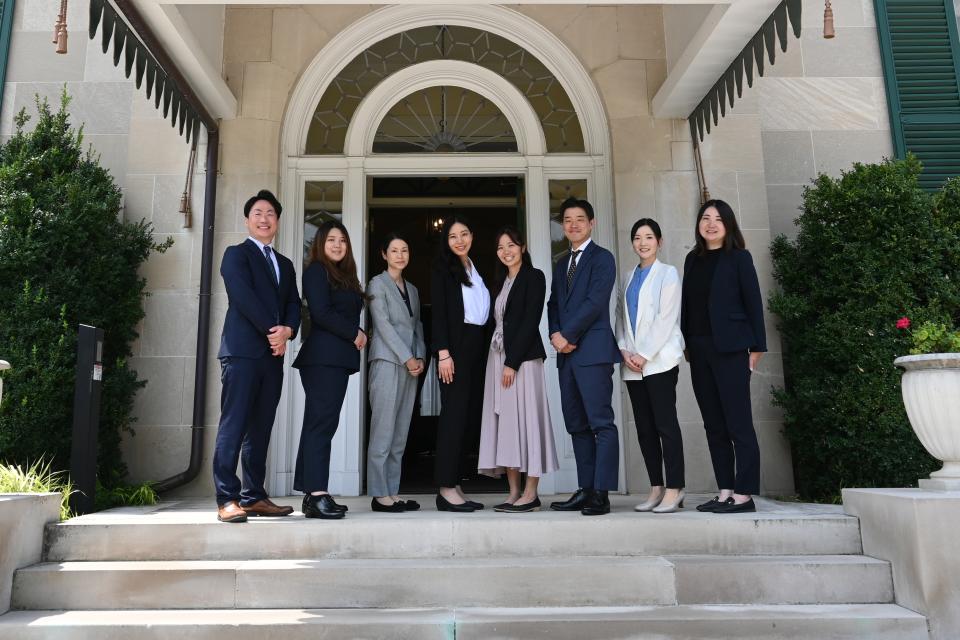 Watanabe fellows standing on steps of residence